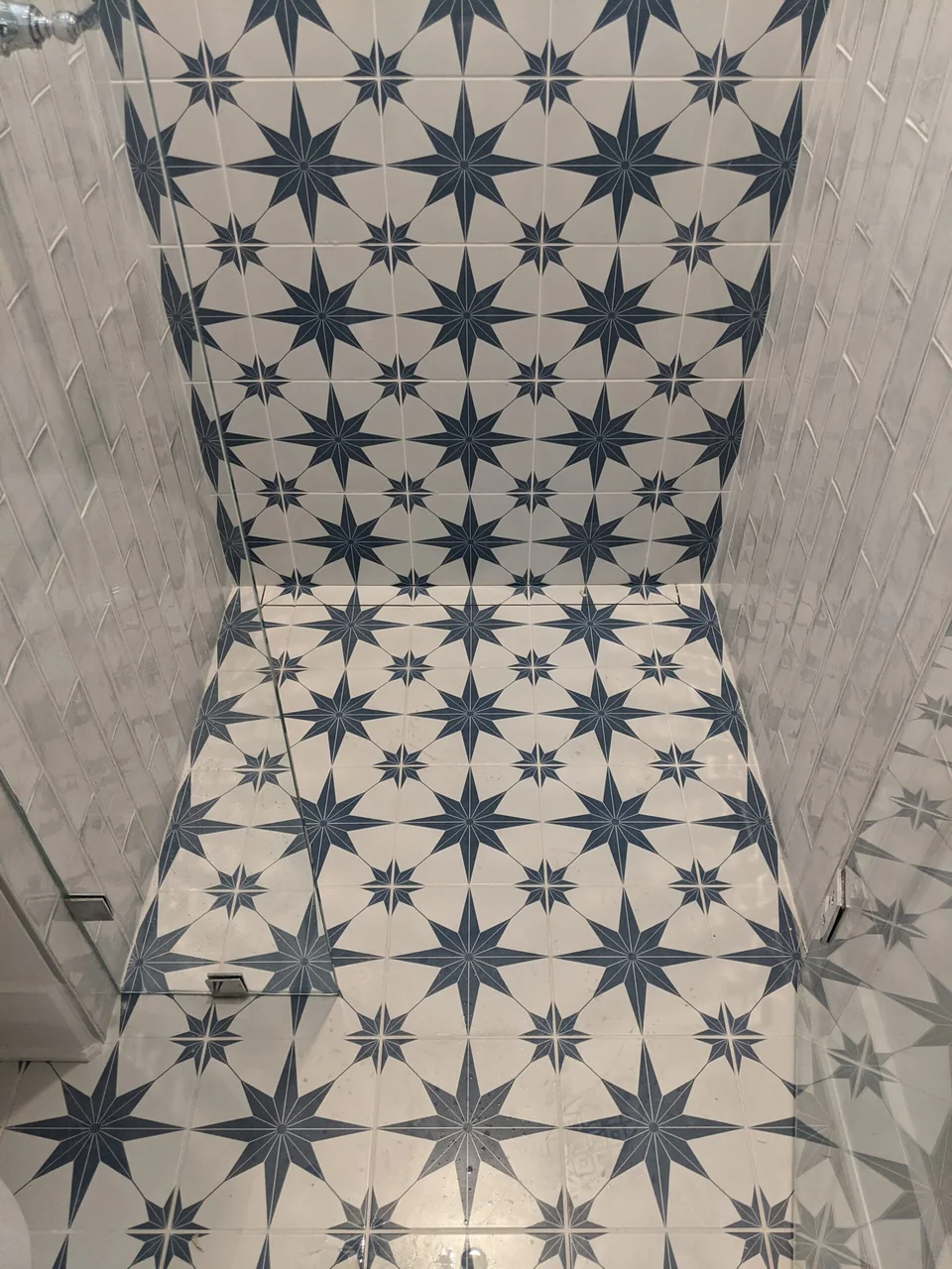 Star-pattern tile at the base of the shower