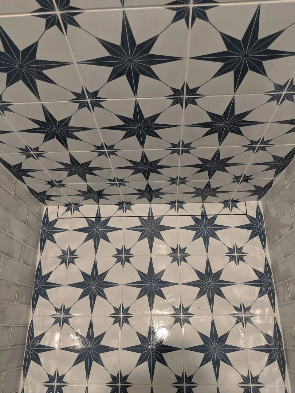 Close view of blue star-pattern shower tile