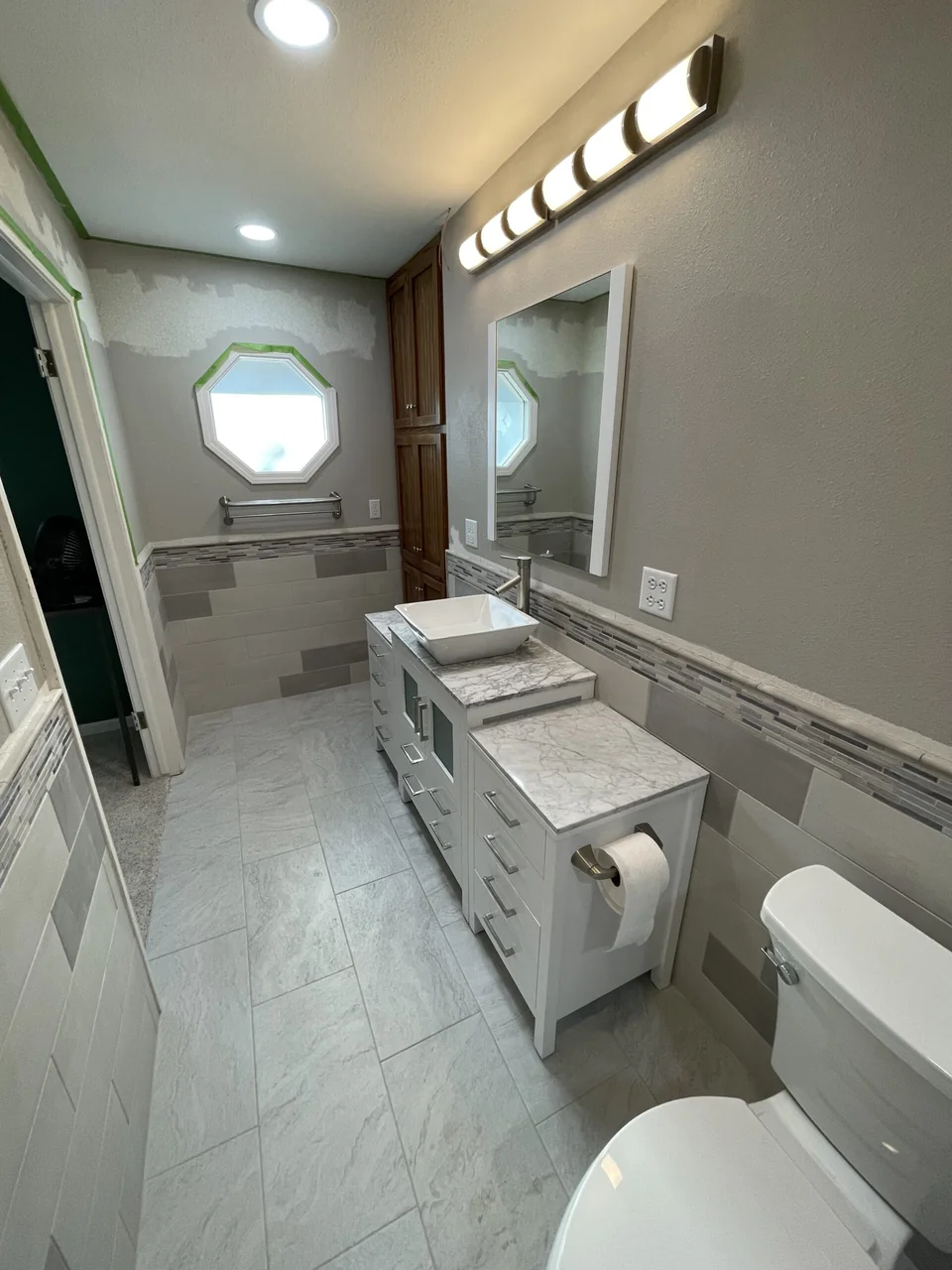 View along the bathroom toward the vanity and shower
