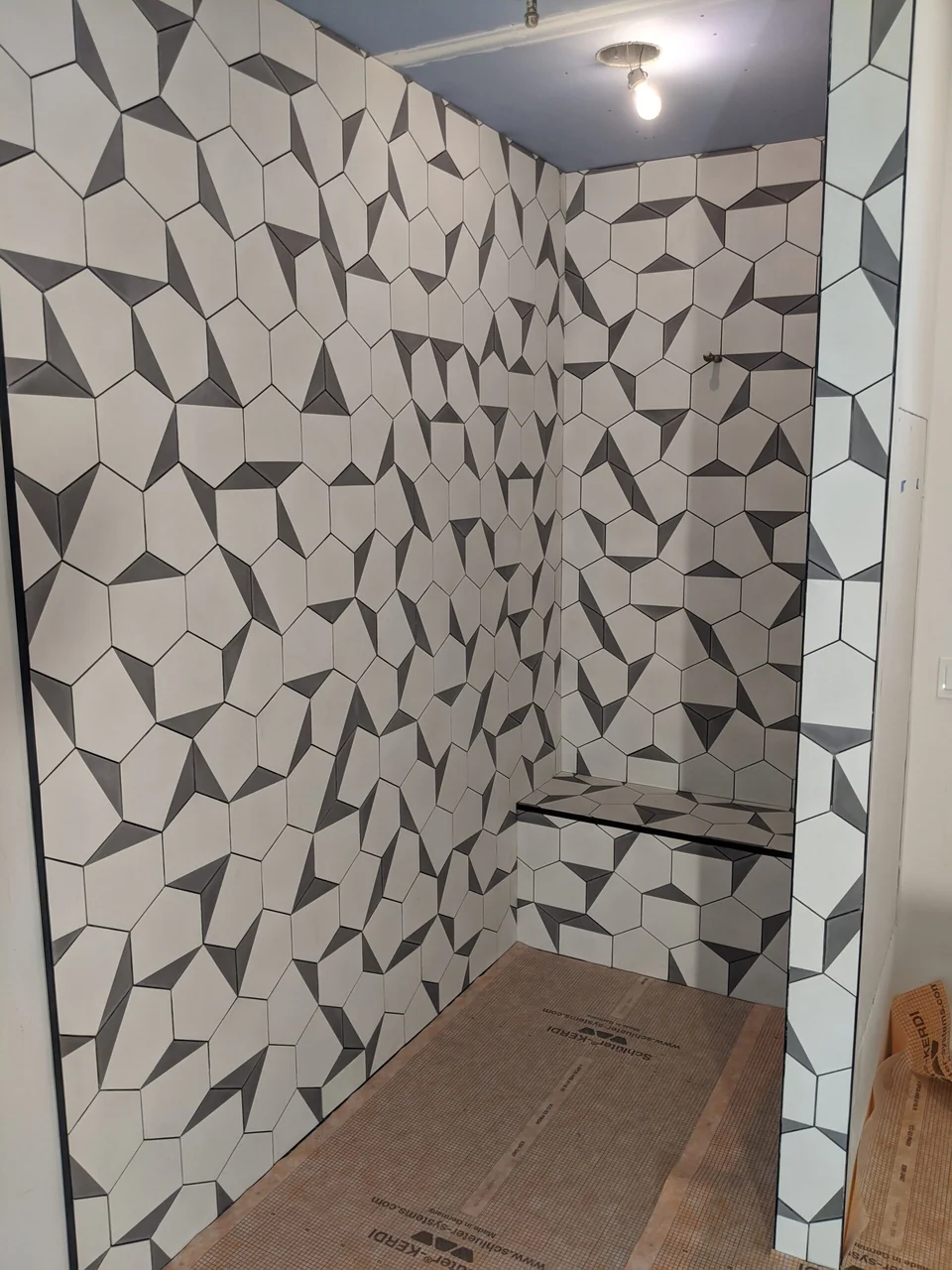 Geometric tile shower viewed from the entry