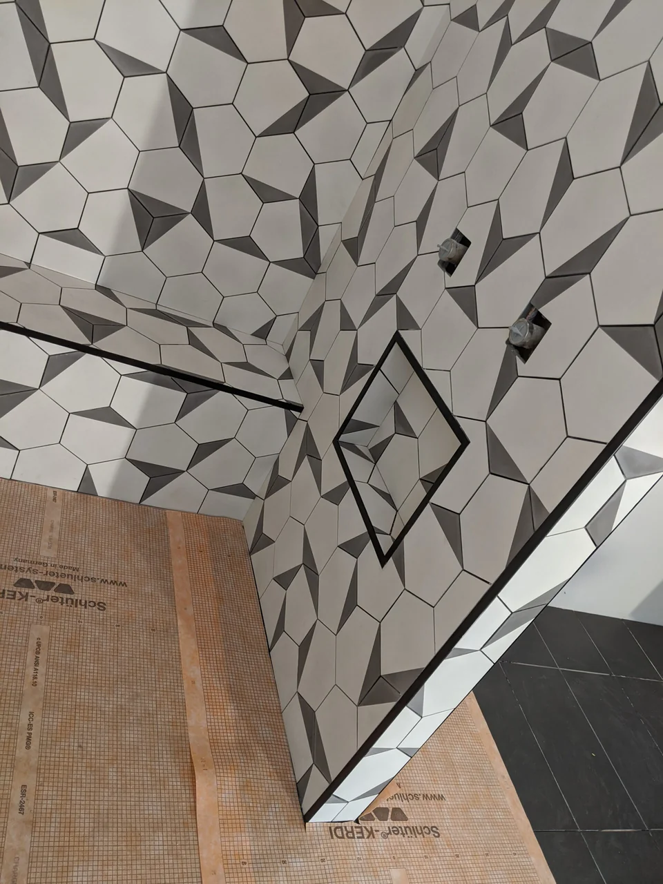 Detail of the geometric tile pattern at a shower corner