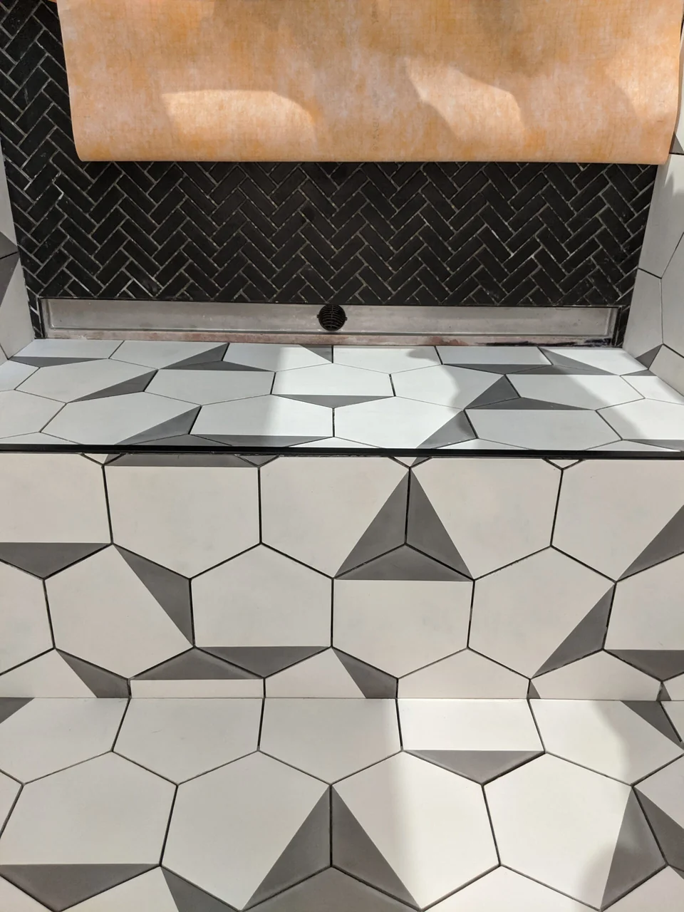 Illuminated niche surrounded by geometric stone tile
