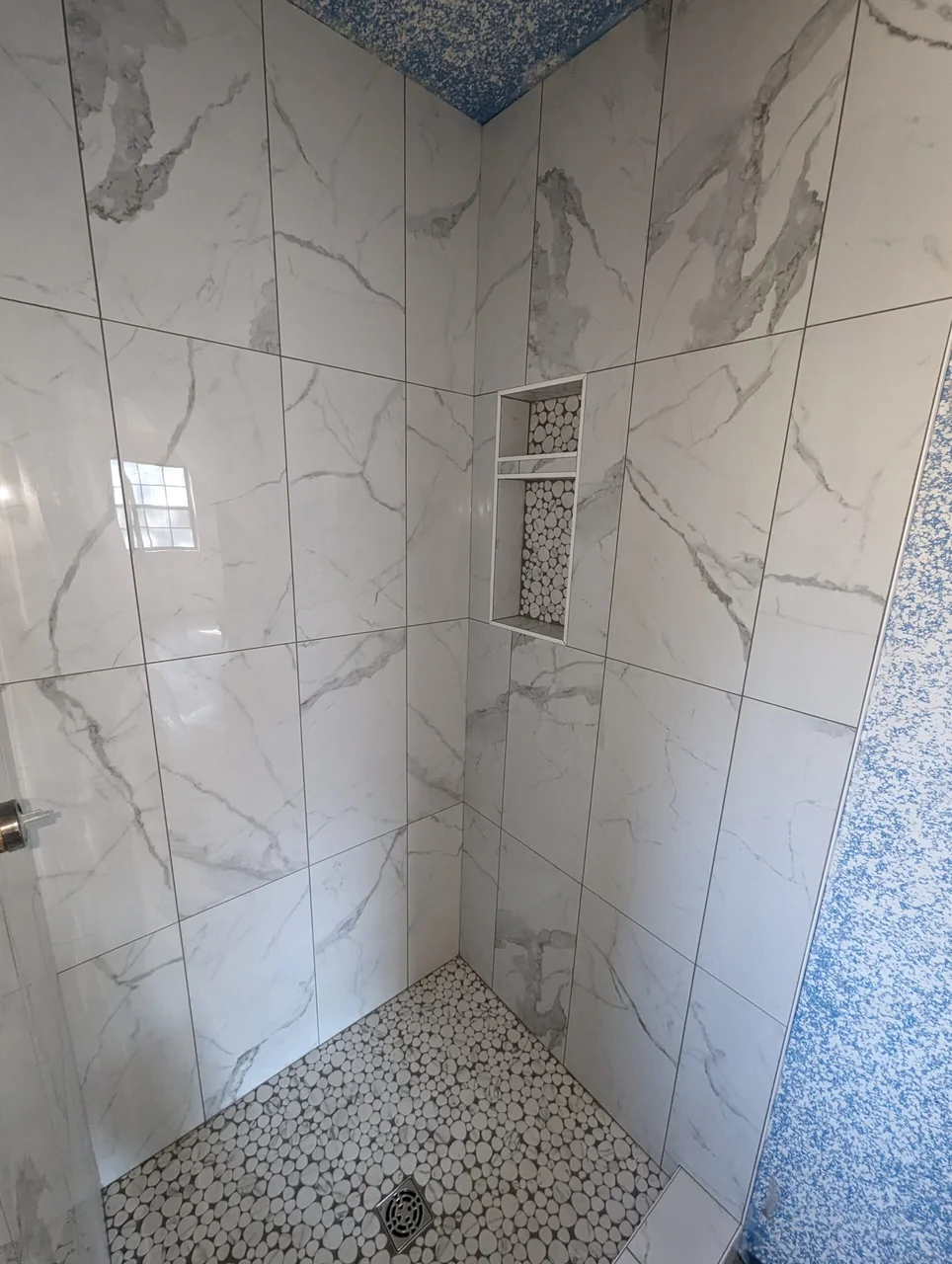 Mosaic shower floor and recessed tile niche