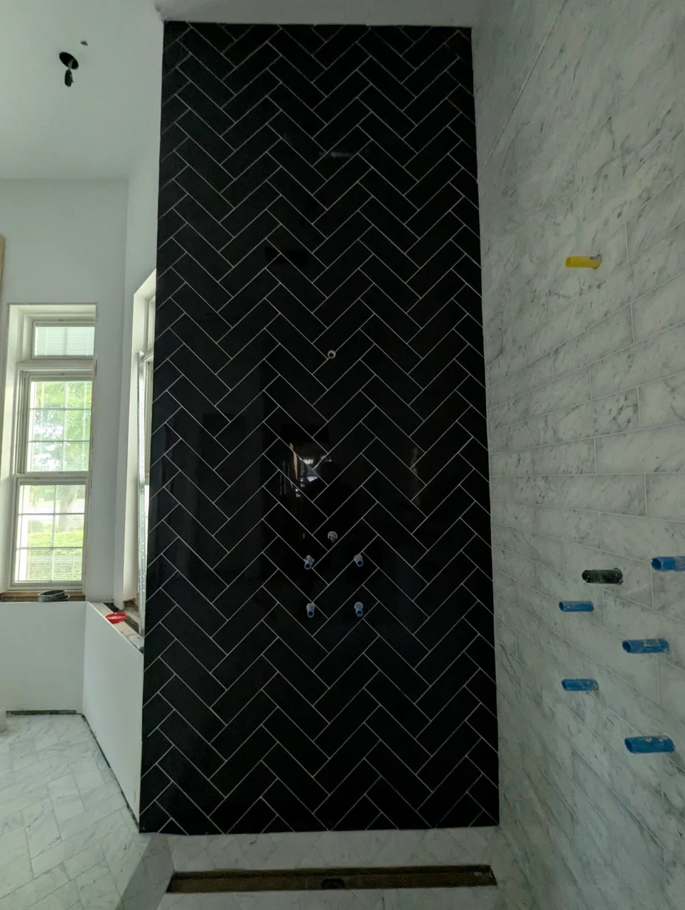 Full-height black herringbone feature wall