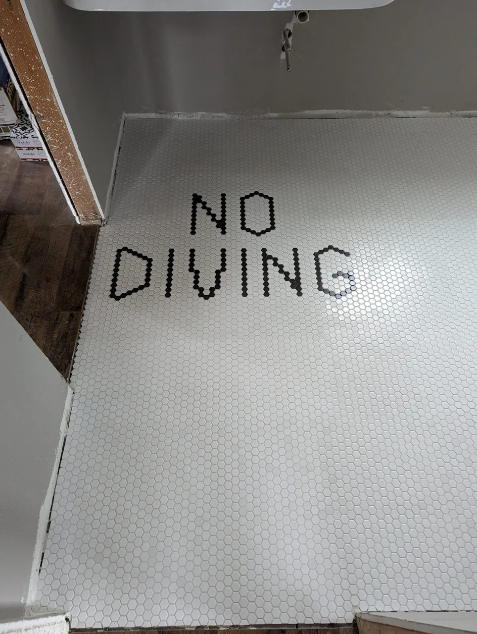 Custom No Diving lettering in a mosaic floor