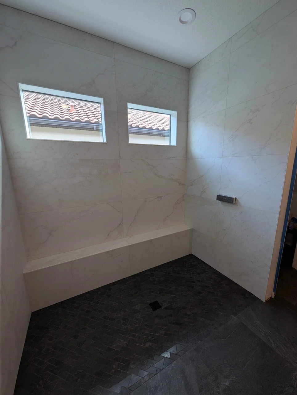 Bathroom with a freestanding tub and tiled shower