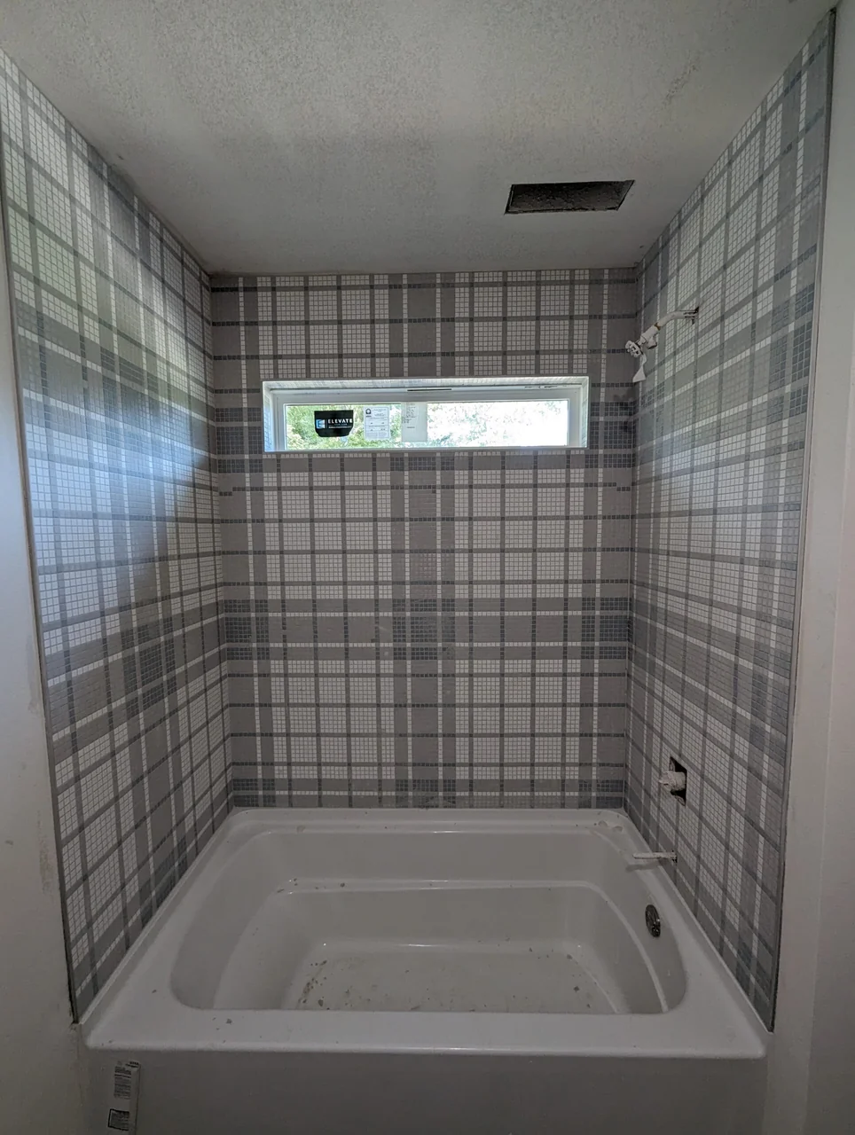 Plaid-pattern tile around a bathtub