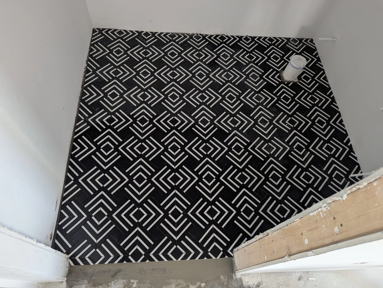 Black and white geometric mosaic tile floor