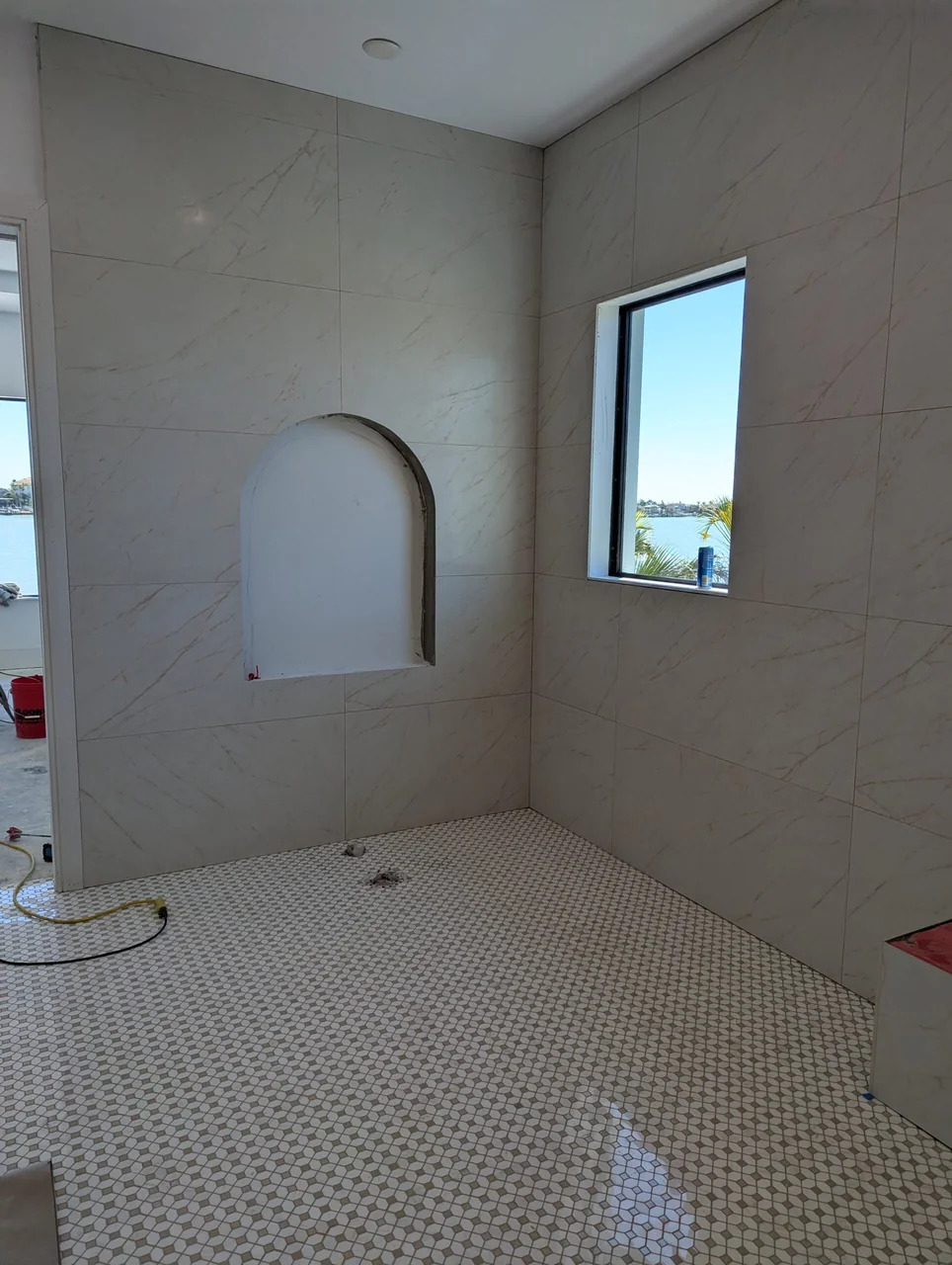 Shower with an arched recessed niche during installation